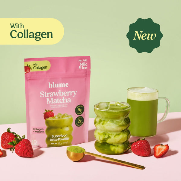 Blume Strawberry Matcha Superfood Powder package with an iced and hot matcha latte, spoon, and strawberries on a pink surface.