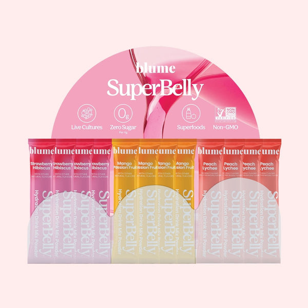 A mockup of Blume SuperBelly Gut-Building Hydration Powder Acrylic Display with sachets of Strawberry Hibiscus, Mango Passion Fruit, and Peach Lychee, on a light pink background.